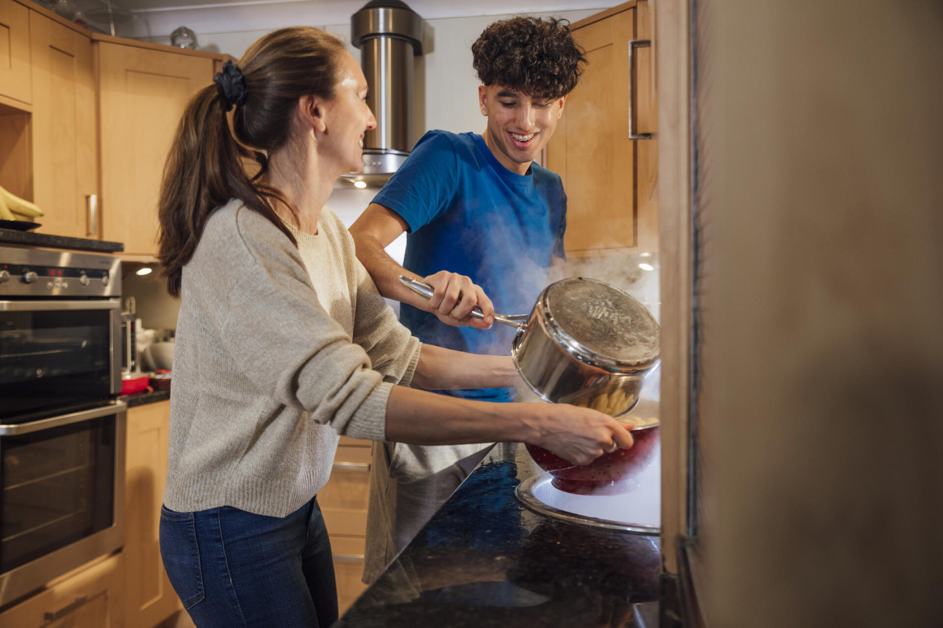 Mom cooking for her teen
