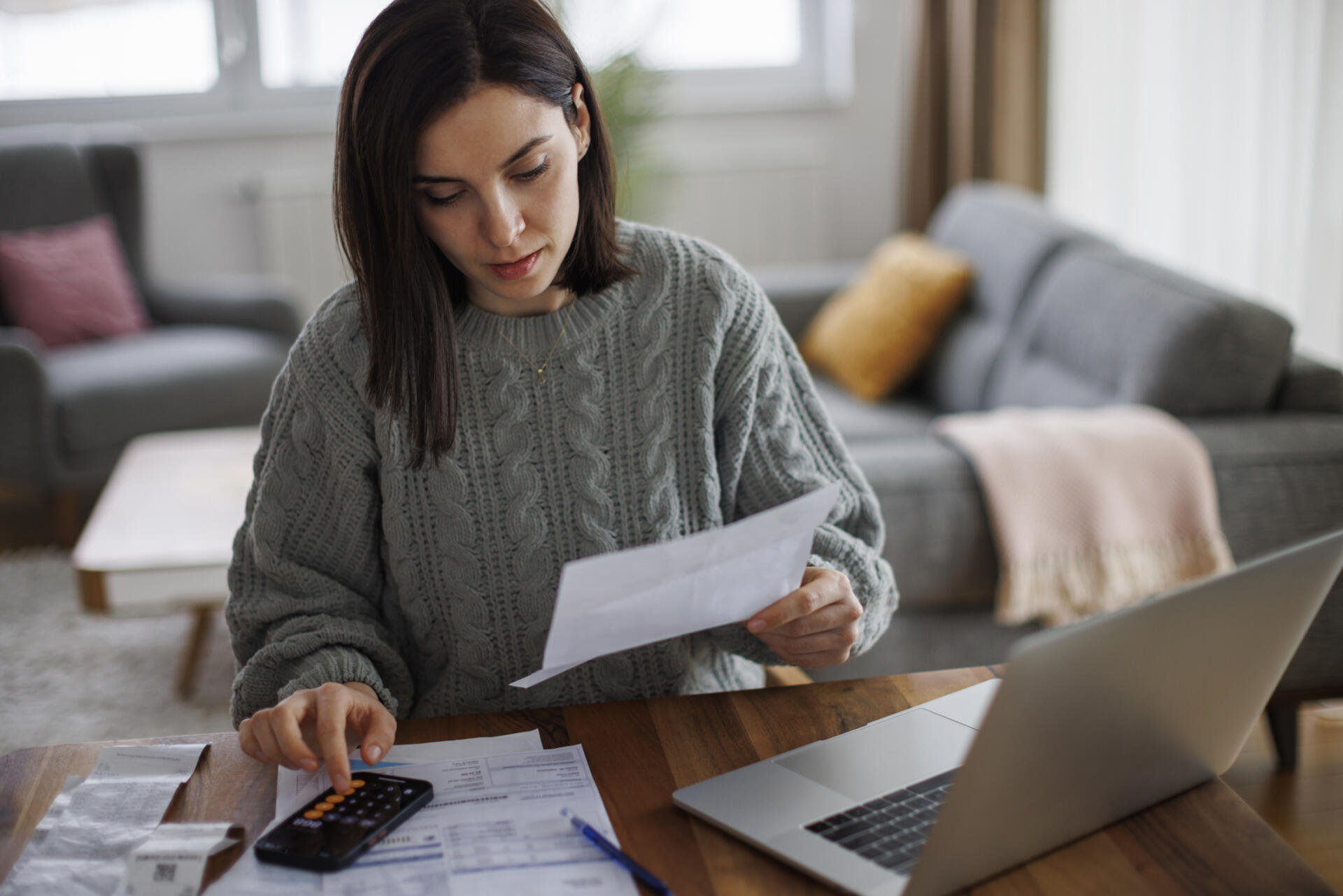 Woman checking her financial expenses and statements at home