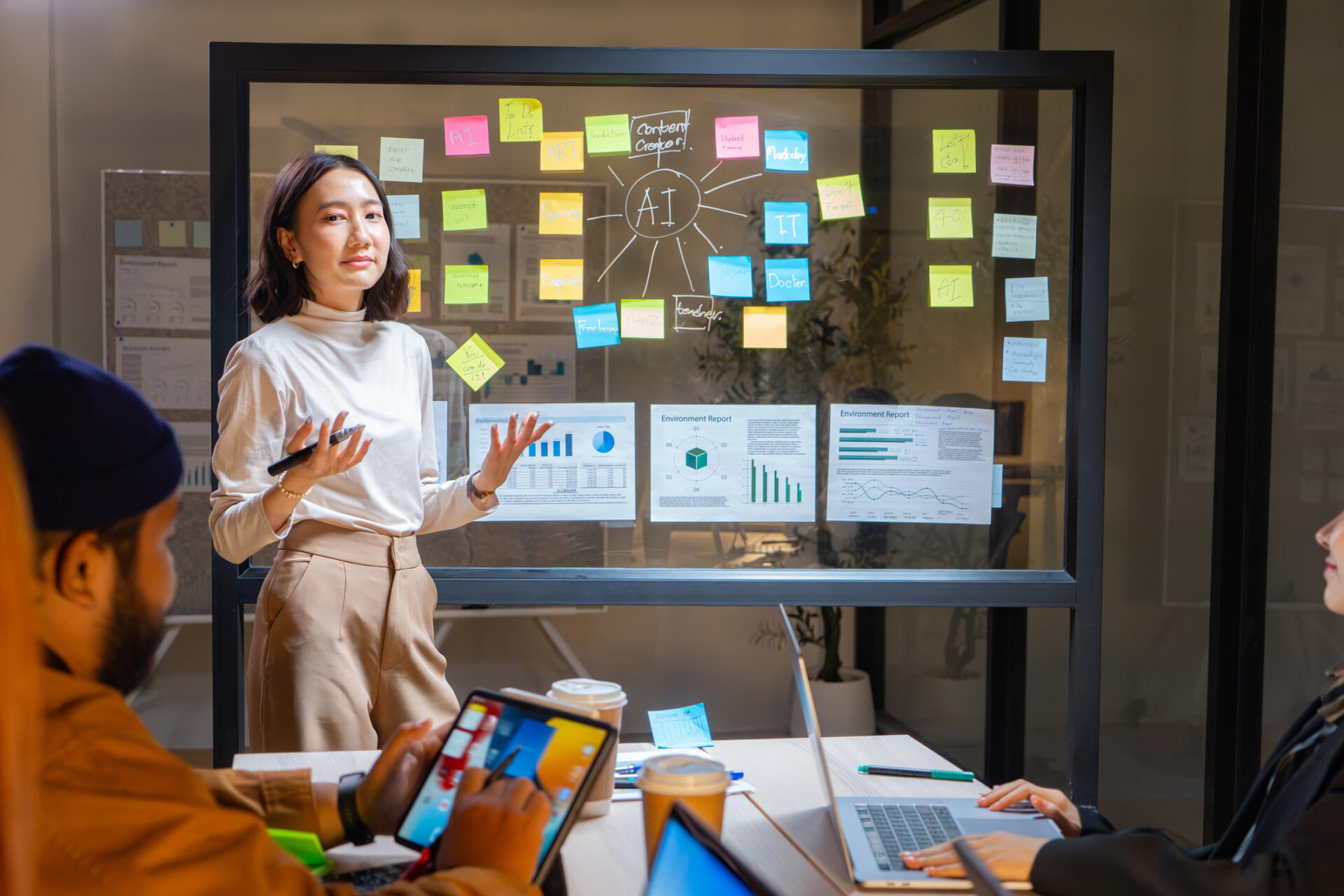 Businesswoman presenting small business artificial intelligence plan in meeting room