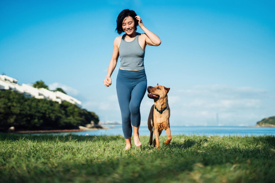 Harness the Power of Walking: Benefits of being Physically Active 2 Woman walking with dog on beach