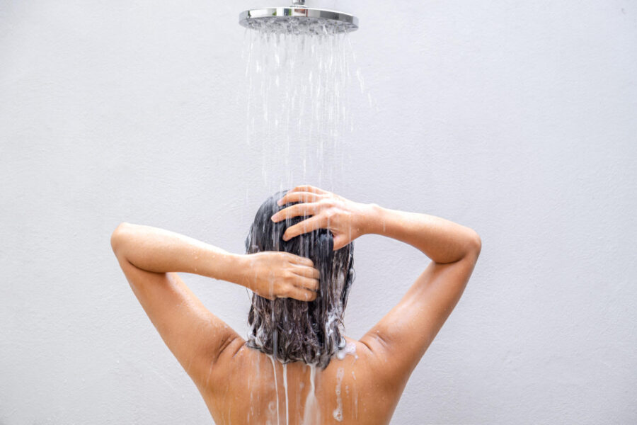 Why Your Home's Water Quality Matters 2 Woman washing her hair and showering